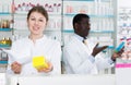 Female chemist dispensing prescription medicines