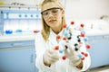 Female chemist hold molecular model in the lab Royalty Free Stock Photo