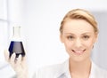 Female chemist holding bulb with chemicals Royalty Free Stock Photo