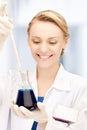 Female chemist holding bulb with chemicals Royalty Free Stock Photo