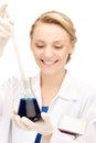 Female chemist holding bulb with chemicals Royalty Free Stock Photo