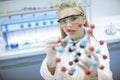 Female chemist hold molecular model in the lab Royalty Free Stock Photo