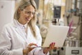 Female chemist working with laptop computer in the lab