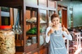 female chicken noodle seller in apron smiling with thumbs up