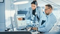 Female Chief Engineer Talks with Male Electronics Specialist, Explaining Things, He Works on Compu Royalty Free Stock Photo