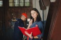 Female chief stands against a worker, during he works at metal c