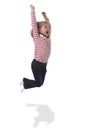 Female child with blond hair jumping happy and crazy rising arms in body language education concept Royalty Free Stock Photo