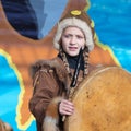 Female child dancing with tambourine in tradition clothing aborigine people Kamchatka. Celebration Koryak national holiday Hololo