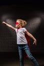 female child flying in red superhero mask