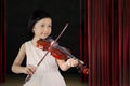 Female child playing a violin on stage