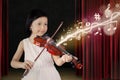 Female child playing violin on stage