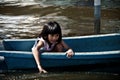 Female child sits on plastic boat