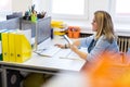 Female child therapist in an office during a phone call, using online calendar to schedule patients appointments. Calendar Planner