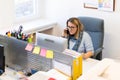Female child therapist in an office during a phone call, using online calendar to schedule patients appointments. Calendar Planner Royalty Free Stock Photo