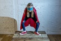 Female child 7 or 8 years old young girl performing happy and excited posing wearing cap and mask in super hero fantasy costume lo Royalty Free Stock Photo