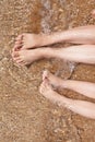 female and childish feet on the sand. rest and sea air. family vacation Royalty Free Stock Photo