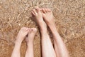 female and childish feet on the sand. rest and sea air. family vacation Royalty Free Stock Photo