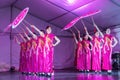 Female Chinese dancers performing with umbrellas on stage Royalty Free Stock Photo