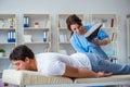 The female chiropractor doctor massaging male patient Royalty Free Stock Photo