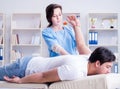 Female chiropractor doctor massaging male patient Royalty Free Stock Photo