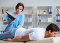 Female chiropractor doctor massaging male patient Royalty Free Stock Photo