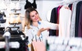 Female is choosing pretty long sleeve shirt Royalty Free Stock Photo