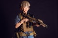 Female civil in tactical uniform with rifle. Shot in studio on black background Royalty Free Stock Photo