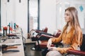 Female client in chair looking in mirror at hairdressing salon. Customer is waiting her stylist in beauty studio while Royalty Free Stock Photo