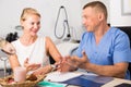 Female client is consultating with doctor before procedure Royalty Free Stock Photo