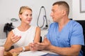 Female client is consultating with doctor before procedure Royalty Free Stock Photo