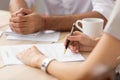 Female client ready to sign contract at meeting with lawyer