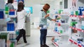 Female client putting boxes of medicaments in basket