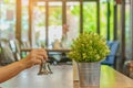 The female client`s right hand hold a small bell to shake for call the waiter