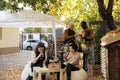 Female client sitting at table with local winemaker tasting homemade natural wine Royalty Free Stock Photo