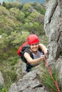 Female climber ascending a rock