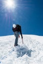 Female climber ascending a snowy slope.