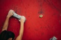 Female climber hands holding artificial boulder in climbing gym, closeup shot