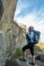 Female climber standing in front of rock