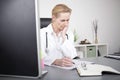 Female Clinician Reading Medical Reports Seriously Royalty Free Stock Photo