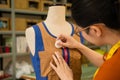 Female clothing design tailor working in dummy