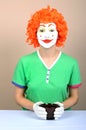 Female clown with cup