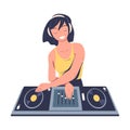 Female club DJ playing music at console mixer. Smiling girl musician in headphones mixing audio records on turntable Royalty Free Stock Photo