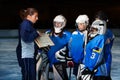Female coach explaining game plan to hockey team Royalty Free Stock Photo