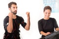 Female coach giving man ems electro muscular stimulation exercise Royalty Free Stock Photo