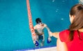 Female Coach In Water Giving preteen boy swimming Lesson In Indoor Pool Royalty Free Stock Photo