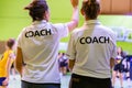 Female coaches in white COACH shirt