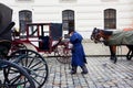 Female coachman in a vintage dress talk on a mobile phone