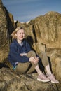 A female on the coastal ocean rocks.