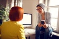 Female colleagues chat in office