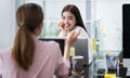 Female colleagues are talking, consulting or gossiping at the Home Office. Two young women sitting at the opposite desk chatted Royalty Free Stock Photo
